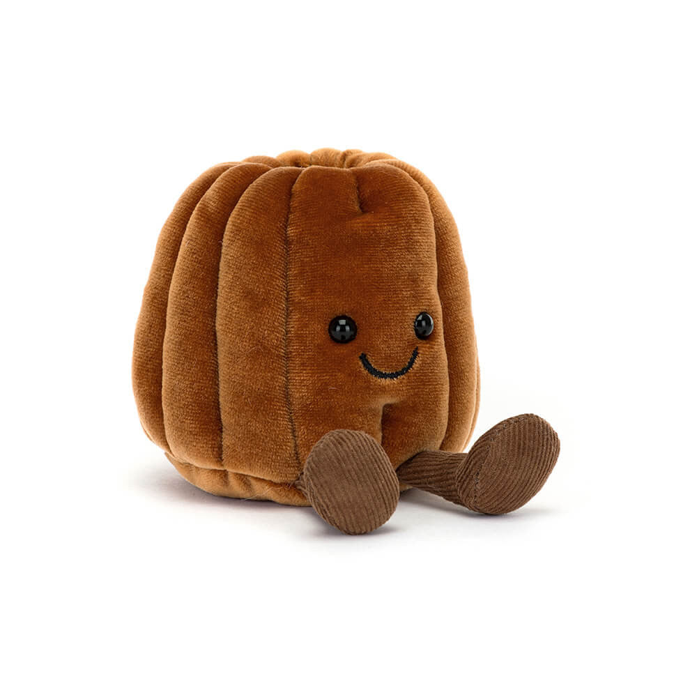 Jellycat brown canelé shaped plush with a smiling face and brown feet on a white background. 