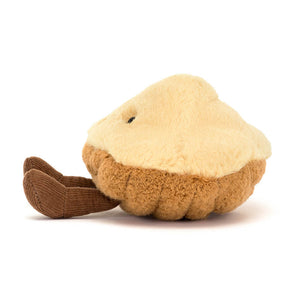 Side view of a Jellycat brown madeleine shaped plush with brown feet on a white background. 