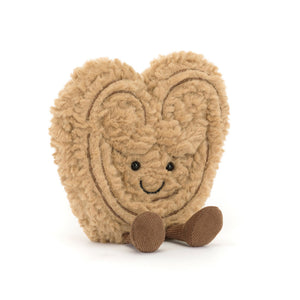 Jellycat light brown heart-shaped palmier plush toy with a smiling face on a white background