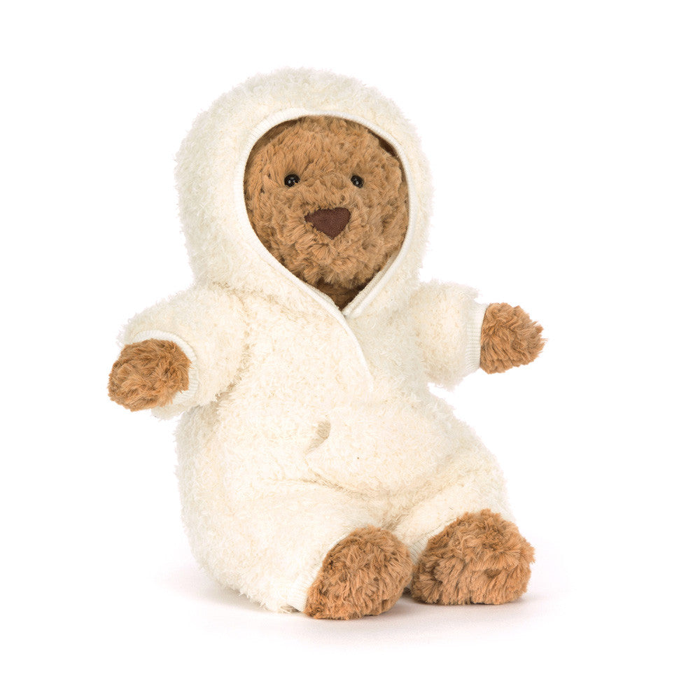 Jellycat brown bear plush wearing a white fleece all in one outfit on a white background. 