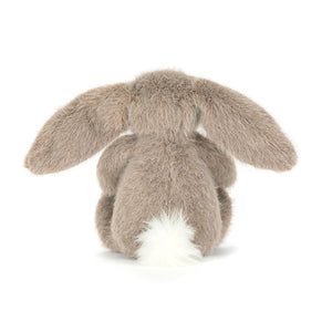 Back view of a Jellycat fawn coloured bunny plush with a white fluffy tail on a white background.