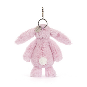 Back view of a Jellycat lilac bunny keychain with a fluffy white tail. The bunny is on a white background. 