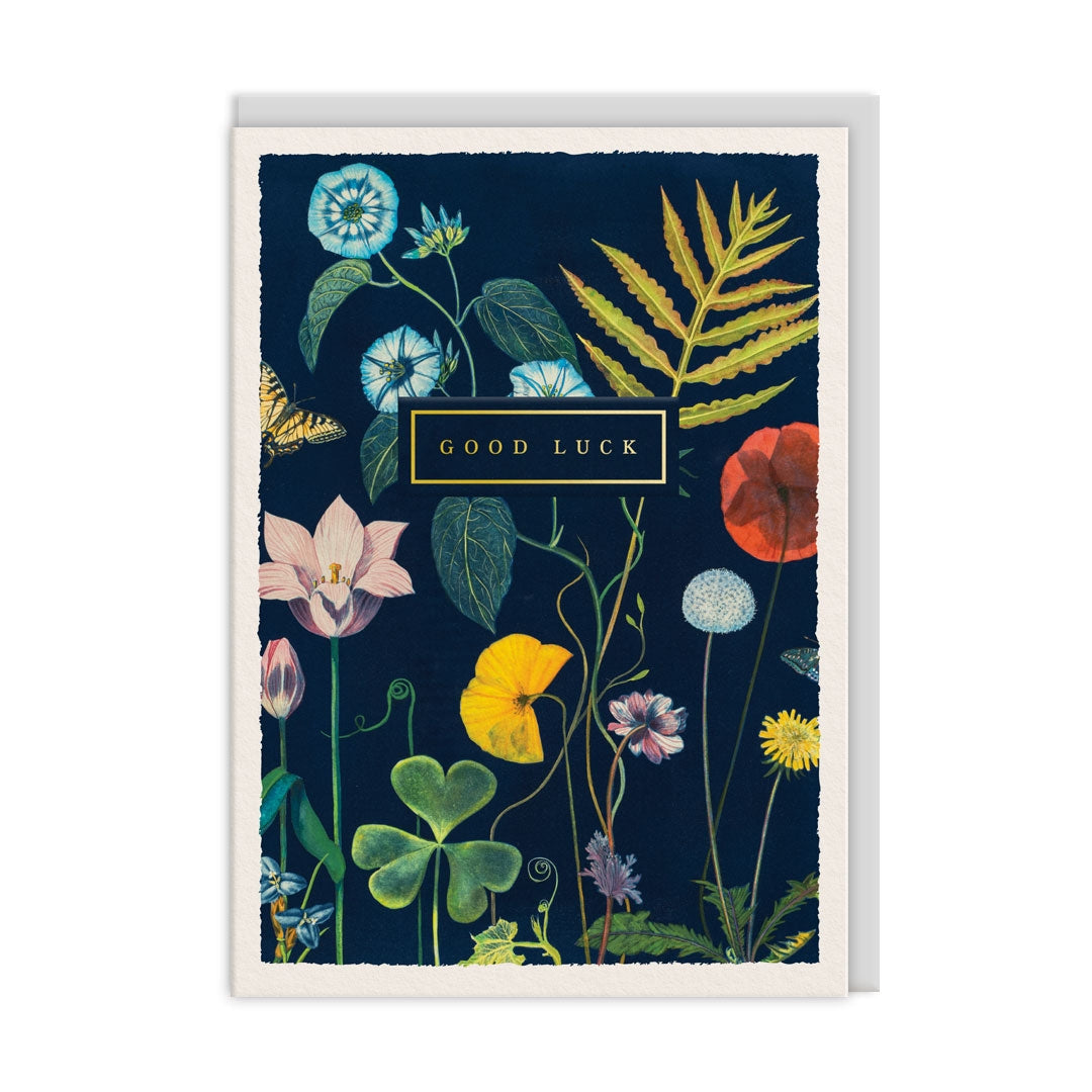 Greeting card with  botanical design and 'Good Luck' text on a dark blue background.
