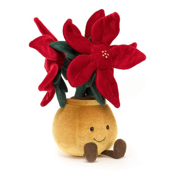 adorably soft plushie of a smiling poinsettia by popular brand Jellycat.