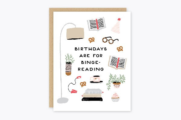 white birthday card with books, plants, pretzels, and coffee mugs. middle text reads "birthdays are for binge-reading"