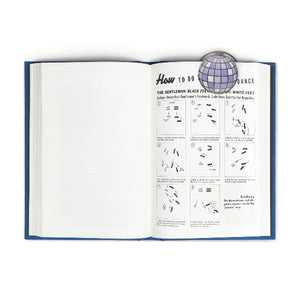 Bookmark with a disco ball design shown clipped onto the page of an open book. 