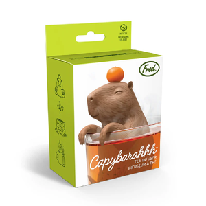 Packaging of Fred & Friends Capybarahhh tea infuser with a capybara-shaped tea infuser balancing an orange on it's head, perched inside a mug of tea.