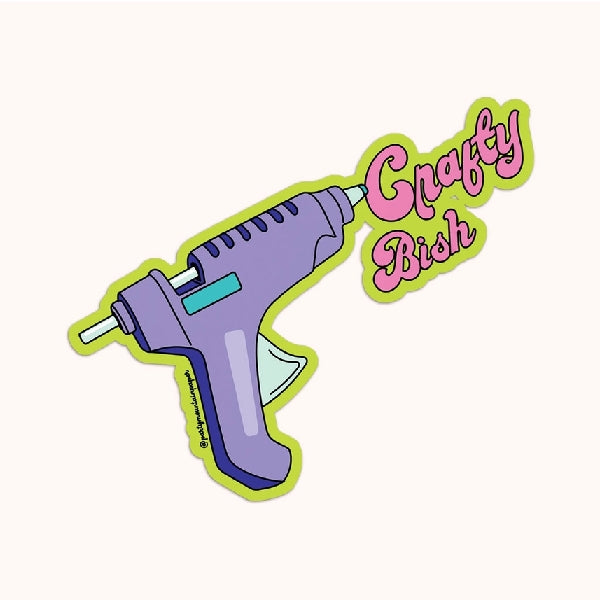 green die-cut sticker of a purple glue gun shooting out the text "crafty bish"