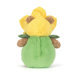 Back view of a brown Jellycat bear plush wearing a green and yellow daffodil outfit on a white background