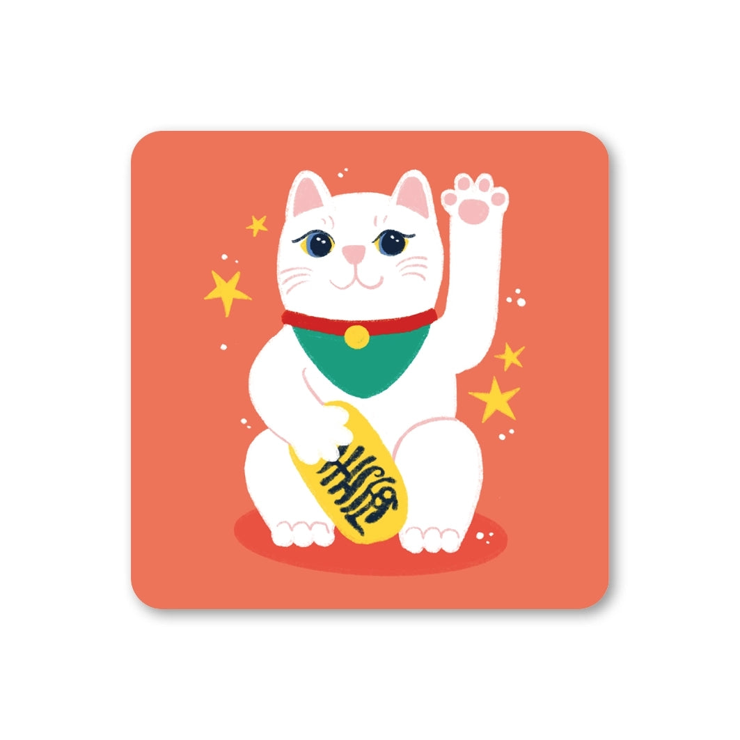 Coaster featuring an illustration of a lucky cat waving it's paw on an orange background with yellow stars. 