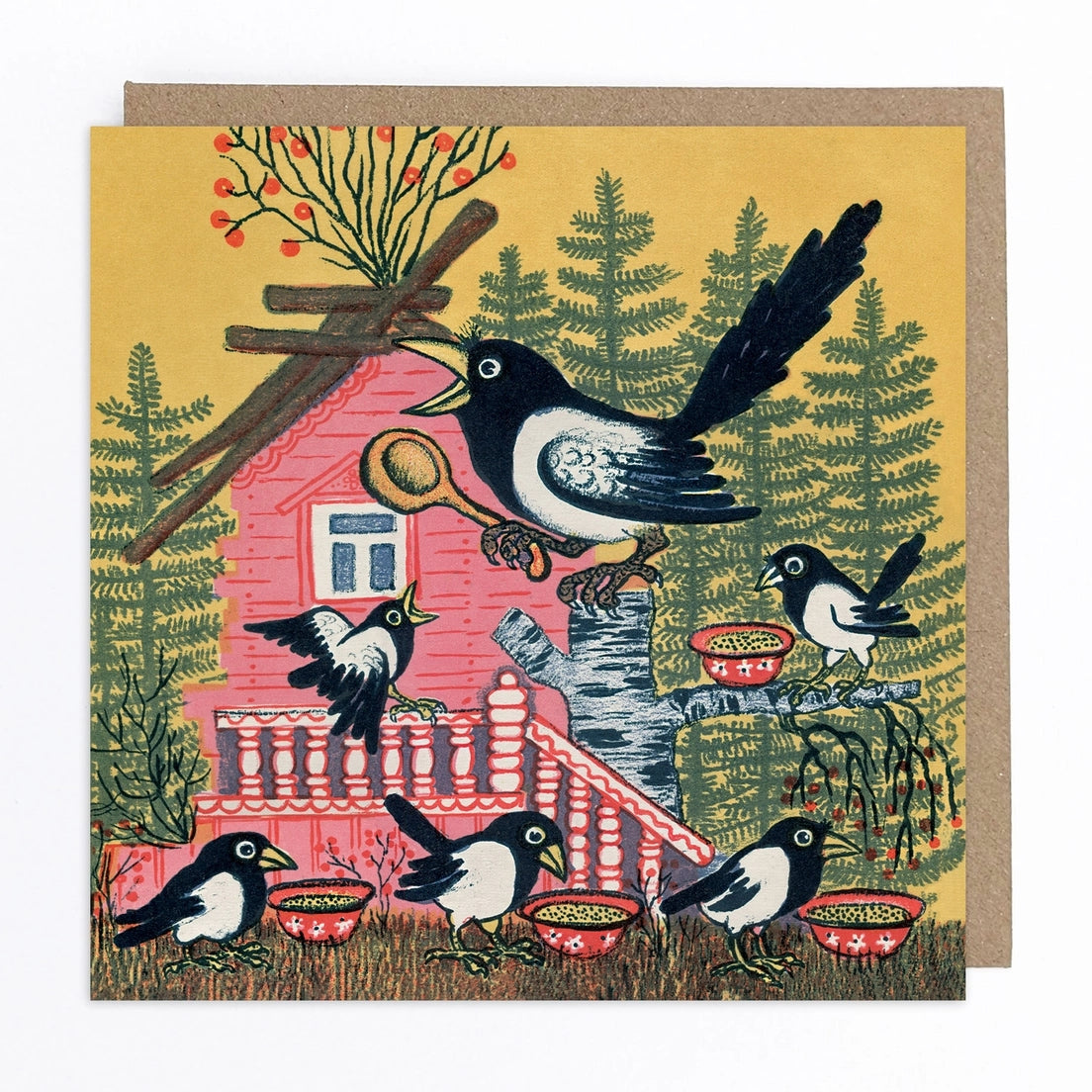 Card featuring a folk art style illustration of six magpies  in front of a pink house against a yellow background. Four of the magpies are sat in front of bowls of food, another sits in front of the house with it's beak open, while the biggest one is perched on a tree gripping a golden spoon in it's foot. 