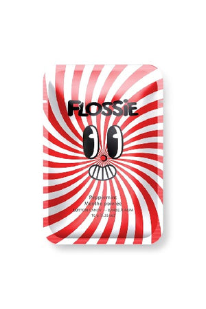 red and white rectangular bag with "Flossie" written in black and a cartoonish facial expression at the centre. the flavour of the candy is written in a smaller font below the smile. the colours of the bag swirl into the middle like a cross between a candy cane and a circus tent pattern