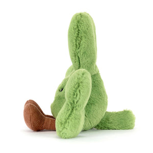 Side view of a Jellycat green clover shaped plush with a smiling face on a white background