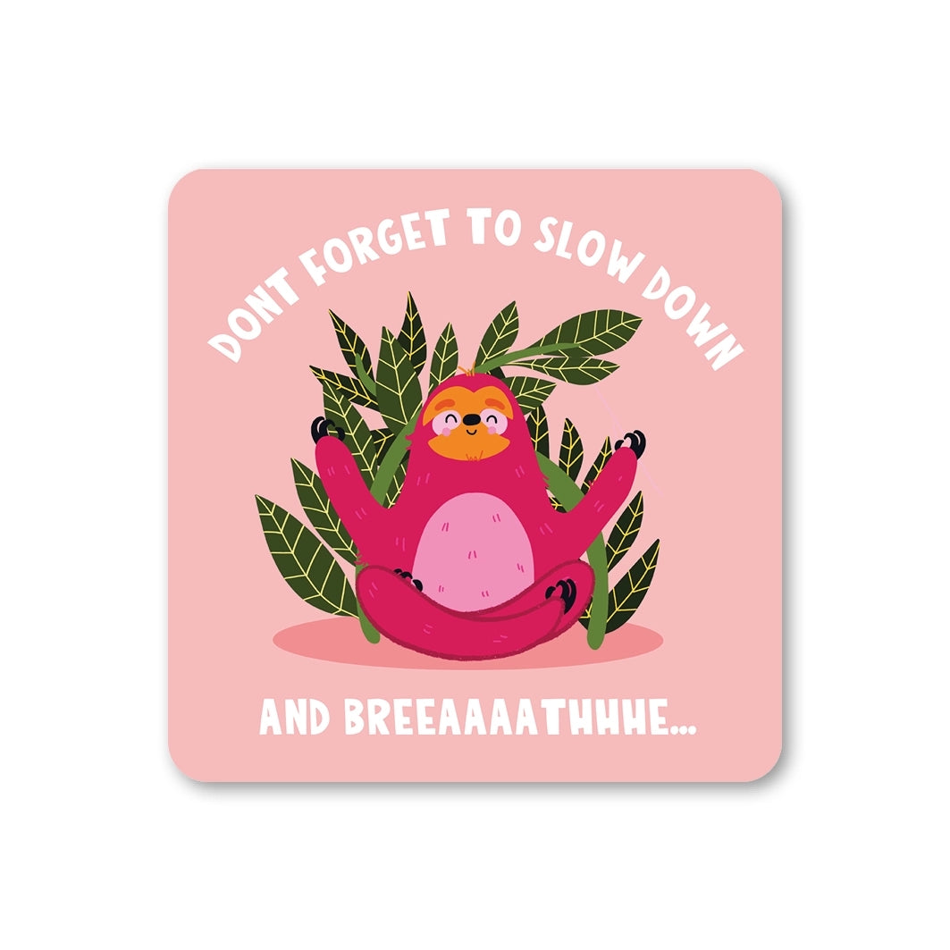 Coaster featuring an illustration of a meditating sloth sitting in front of trees with the text 'Don't forget to slow down and breeaaaathhhe...' on a pink background.
