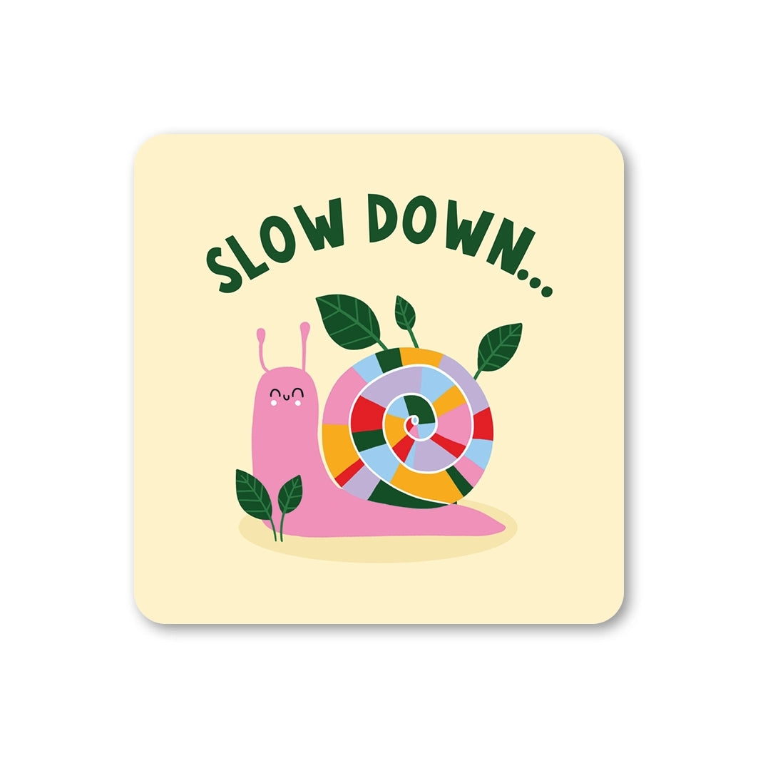 Coaster featuring a pink snail with a colourful shell, featuring the text 'Slow Down...' on a yellow background.