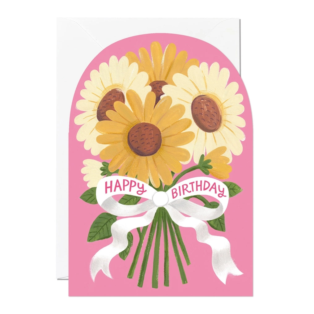 Greeting card featuring a colourful illustration of sunflowers tied with a white ribbon on a pink background with the text 'Happy Birthday' printed on the ribbon. 