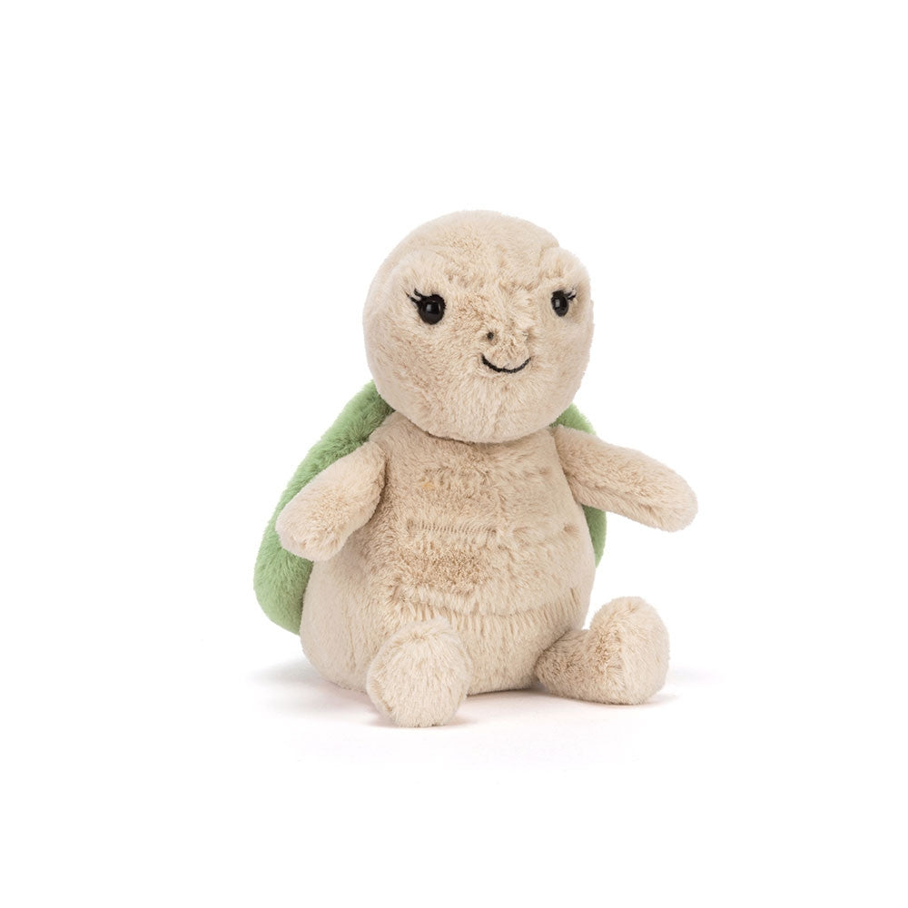 Front view of a Jellycat turtle plush with a smiling face on a white background