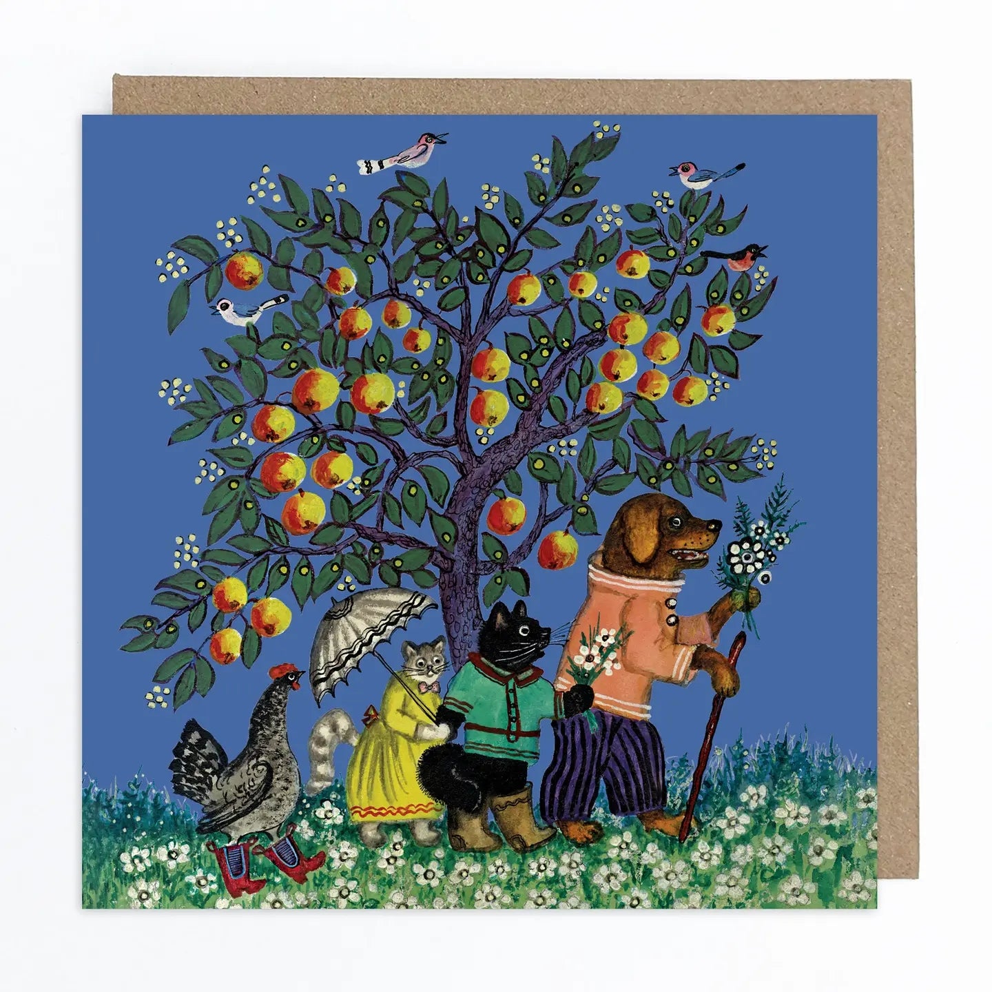 Greeting card featuring a folk art style illustration of a clothed dog, two cats and a hen walking under an apple tree on some grass with flowers. The apple tree is set against a blue sky with some birds perched on the branches. 