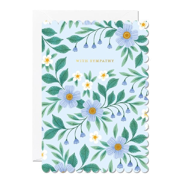 Greeting card with a scalloped edge featuring a blue, white and yellow floral illustration with the text 'With Sympathy'.