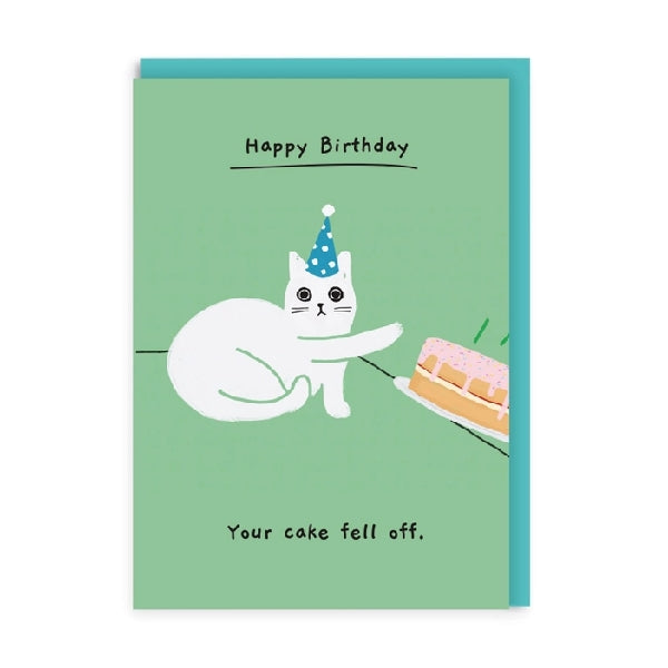 Green greeting card with an illustration of a white cat wearing a party hat, knocking a cake off the table with 'Happy Birthday' text and the phrase 'Your cake fell off'.