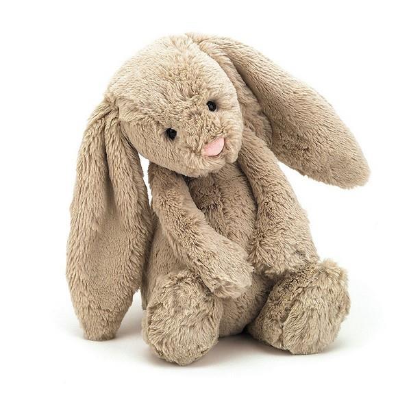 adorably soft plushie of a bashful beige bunny by popular brand Jellycat.
