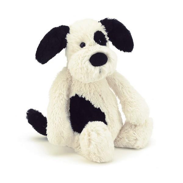 adorably soft plushie of a white and black dog by popular brand Jellycat.